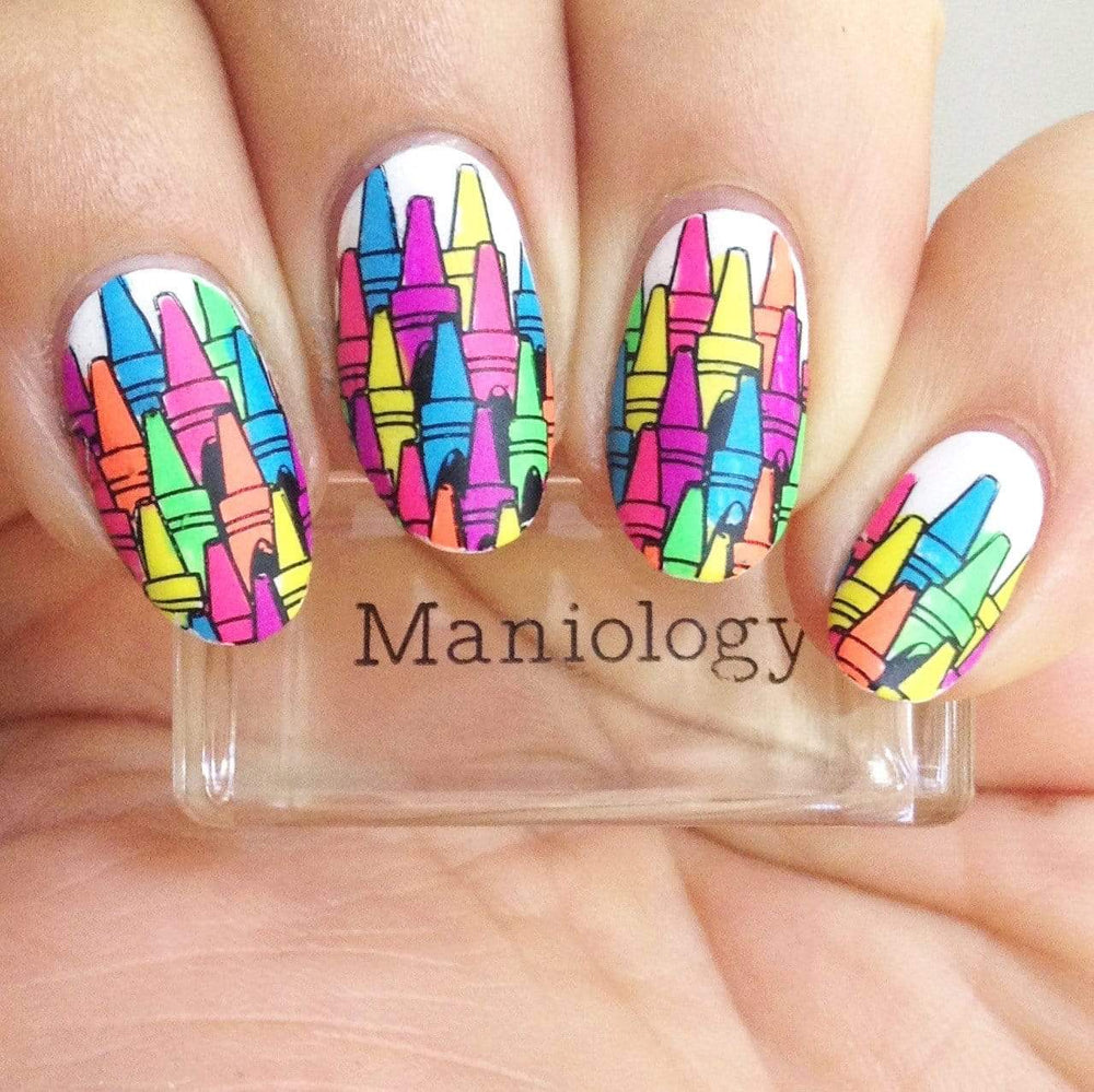 A manicured hand with colorful crayons design holding a stamper.