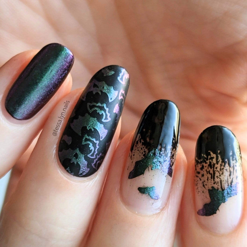 A manicured hand in black with bats designs by Maniology (m151).