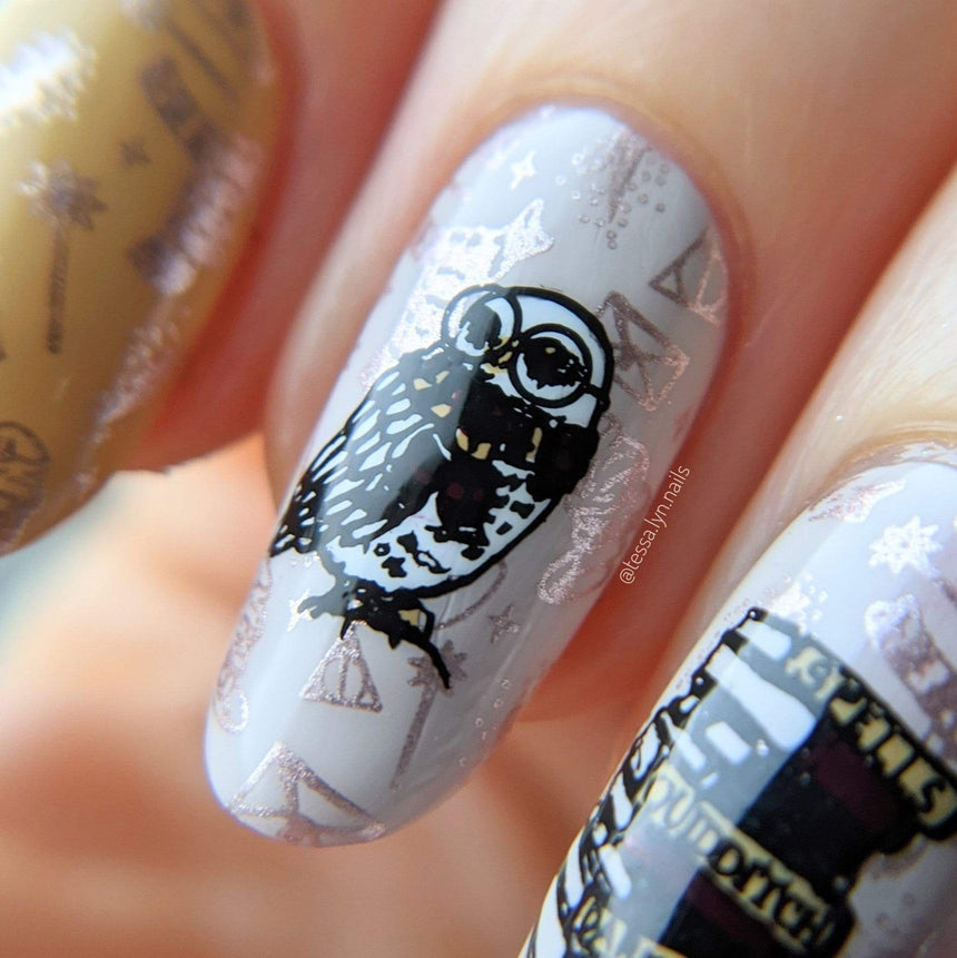 A manicured hand with owl, spellbooks designs by Maniology (m152).