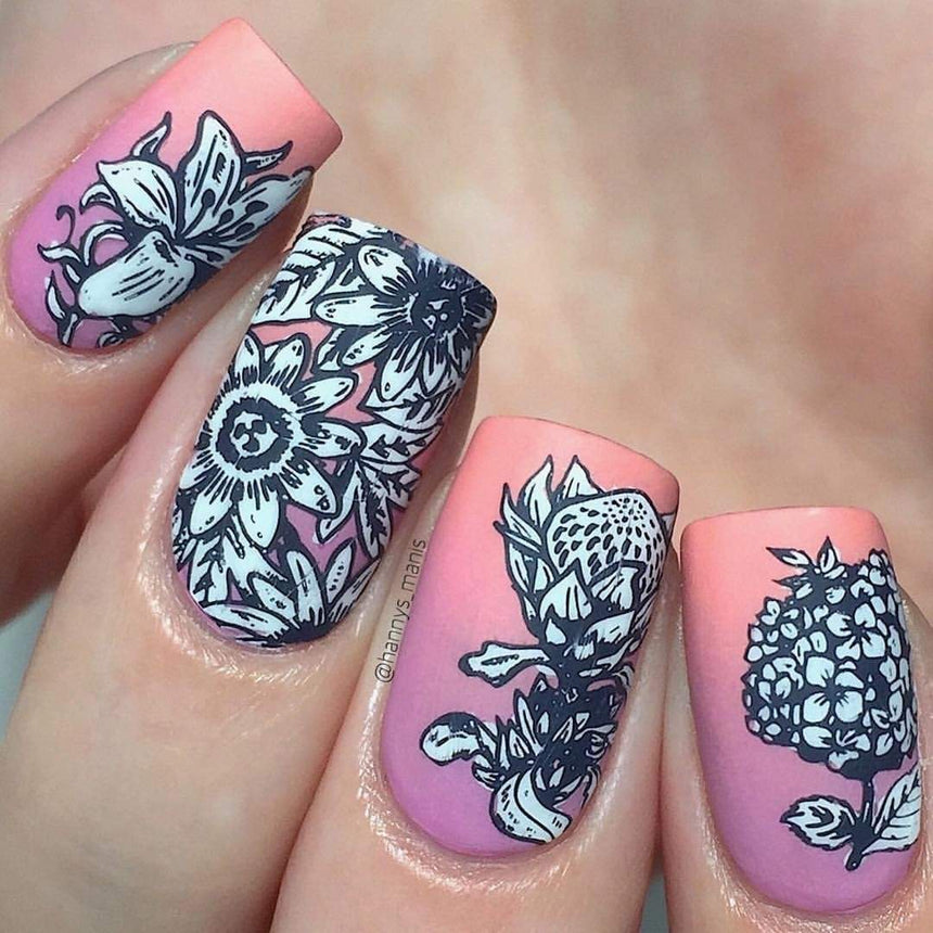 A manicured hand in pink and white with blooming flower designs.