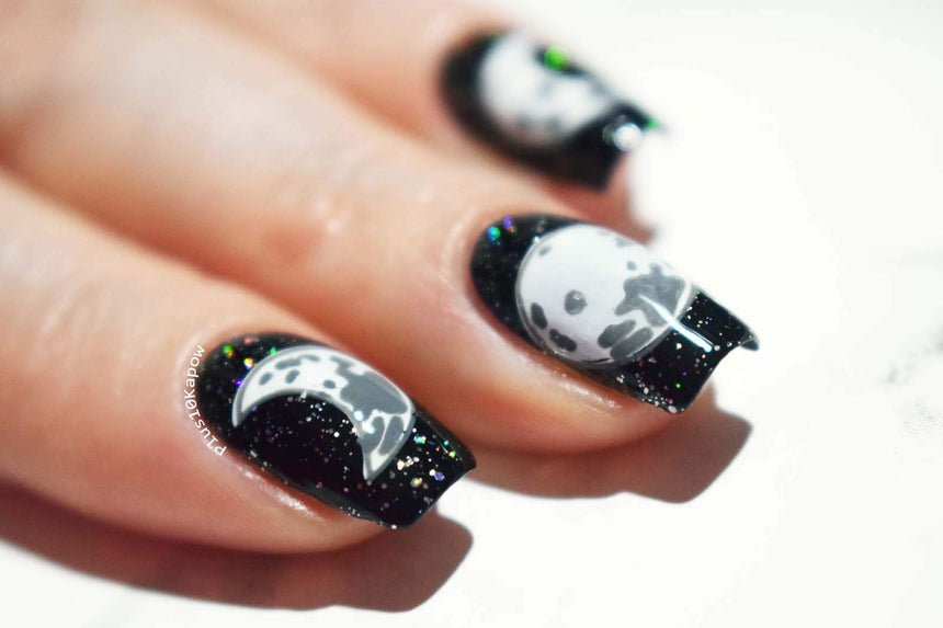 A manicured hand with Crystal moon design by Maniology (m119).