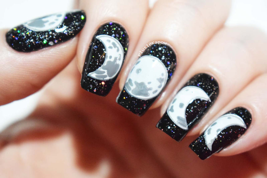 A manicured hand with Crystal moon designs by Maniology (m119).