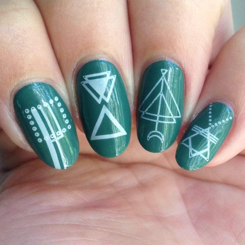 A manicured hand with geometric designs by Maniology (m119).