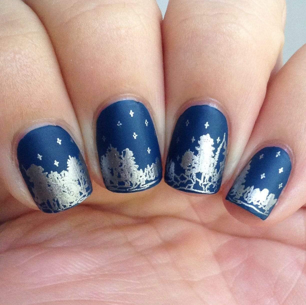 A manicured hand in blue with trees design by Maniology (m101).