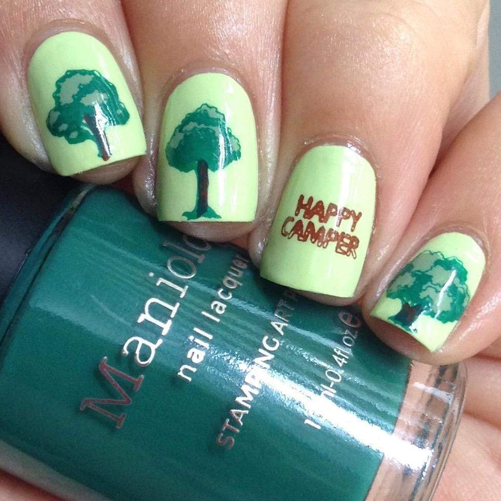  A manicured hand with trees design holding a stamping polish by Maniology (m101).