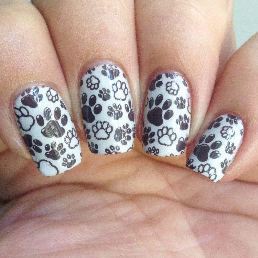 A manicured hand in black and white with dog paws design by Maniology Puppy Love (m097).
