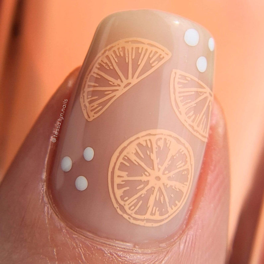 A manicured hand with watermelon designs by Maniology Sun & Sand (m104).