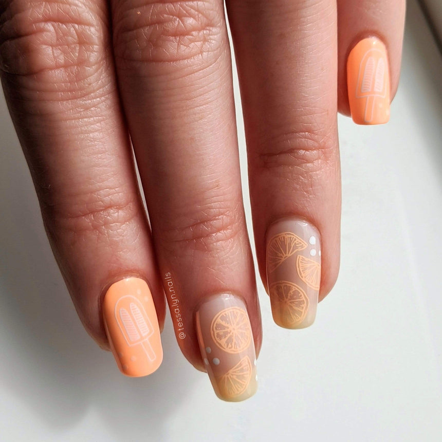 A manicured hand with popsicles and watermelon designs by Maniology Sun & Sand (m104).