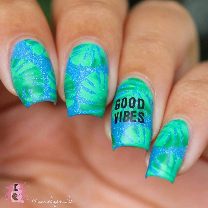 A manicured hand with leaves and the words Good Vibes design by Maniology Wave Your Palms (m095).