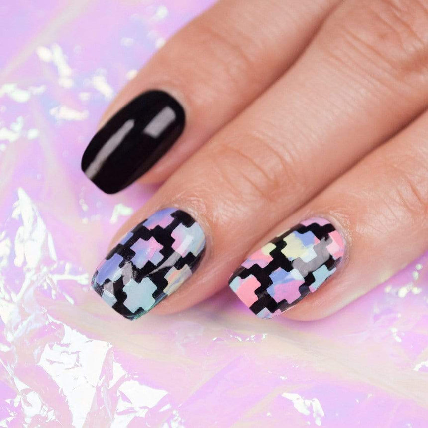 A manicured hand with geometric designs