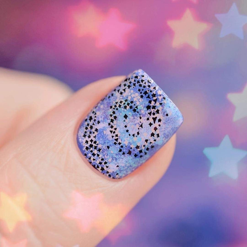 A manicured hand with Stargazer design by Maniology (m012).