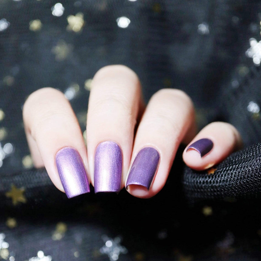 A manicured hand with the use of Dearest Aurora stamping polish