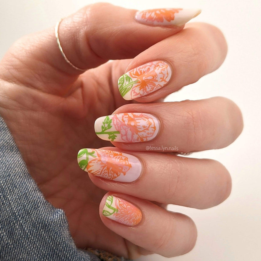 A manicured hand with floral designs by Maniology (m179).