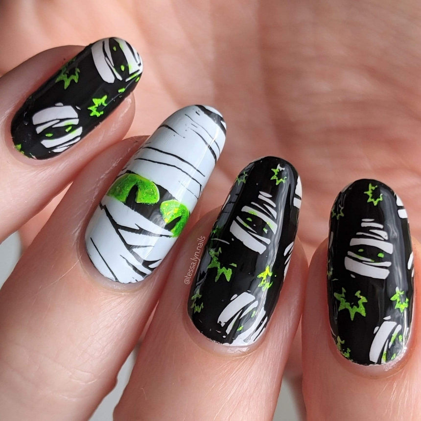 A manicured hand with mummies design by Maniology (m158).