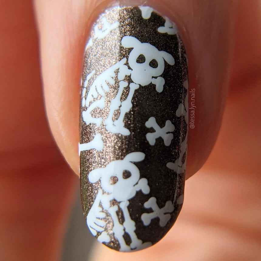 A manicured hand with bad to the bones designs by Maniology (m158).
