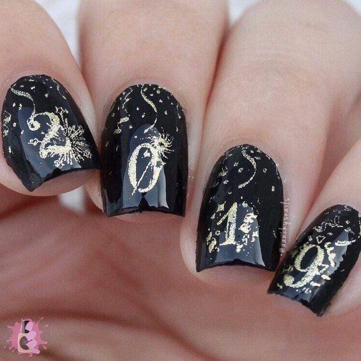 A manicured hand in black with fireworks and numbers design.