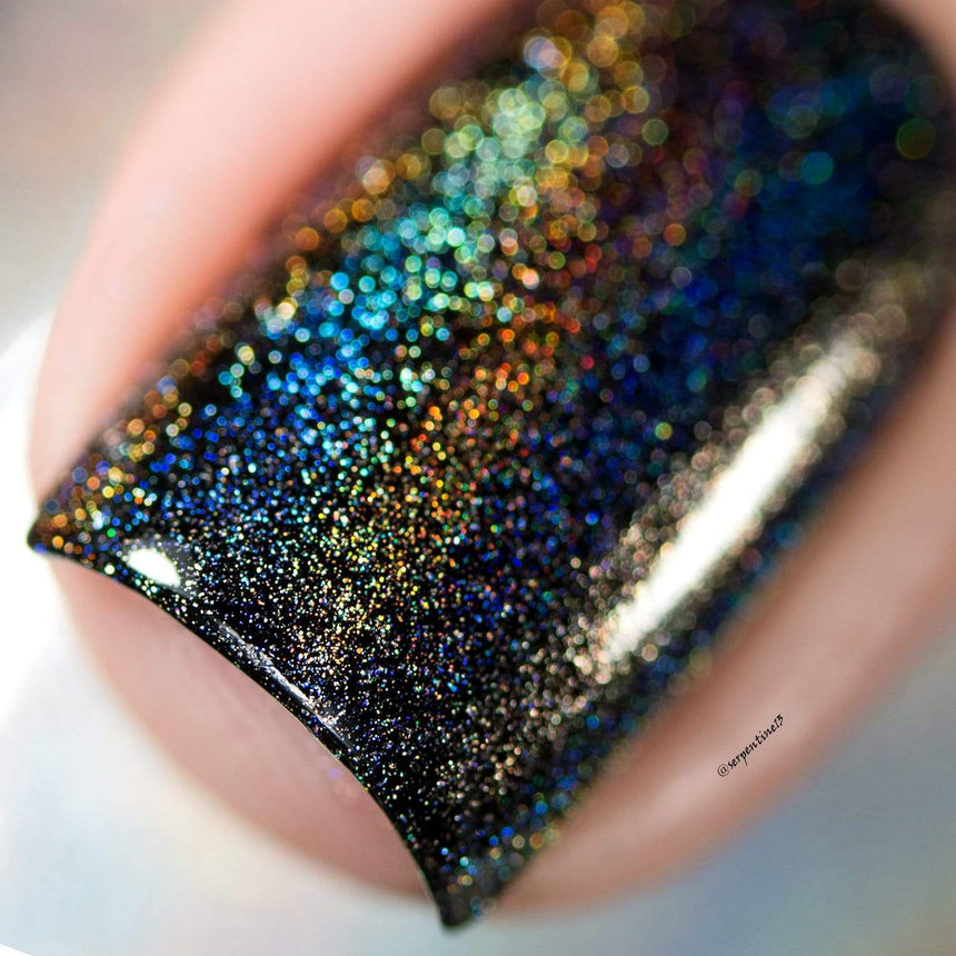 A manicured hand made with Holo Prism Top Coat by Maniology.