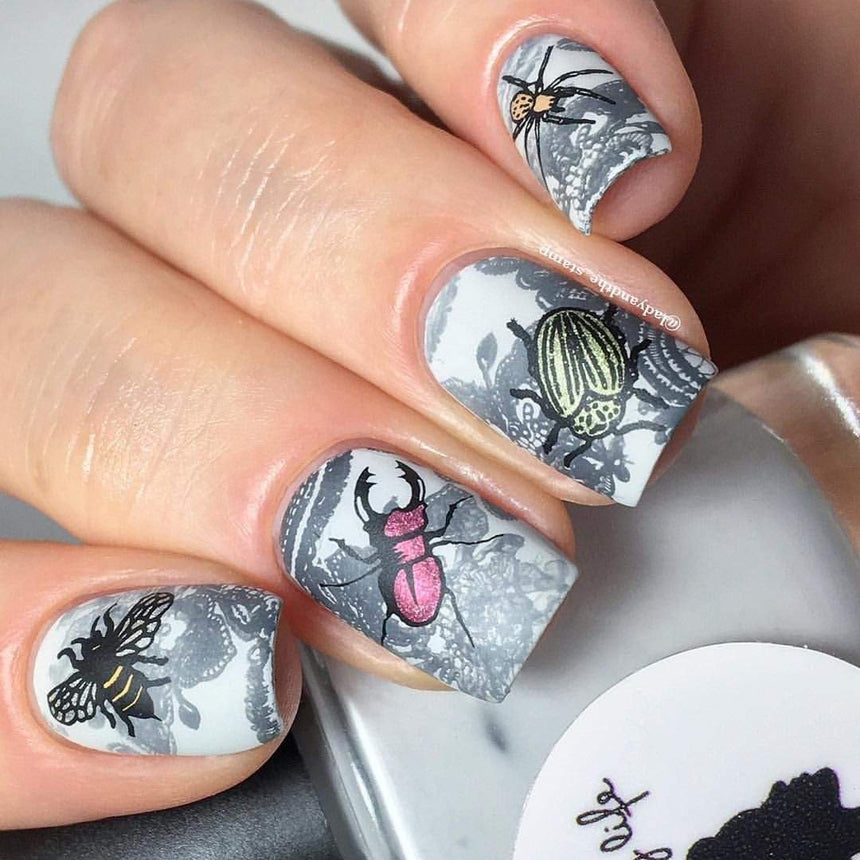 A manicured hand with Blood Suckers design by Maniology (m064) holding a polish.