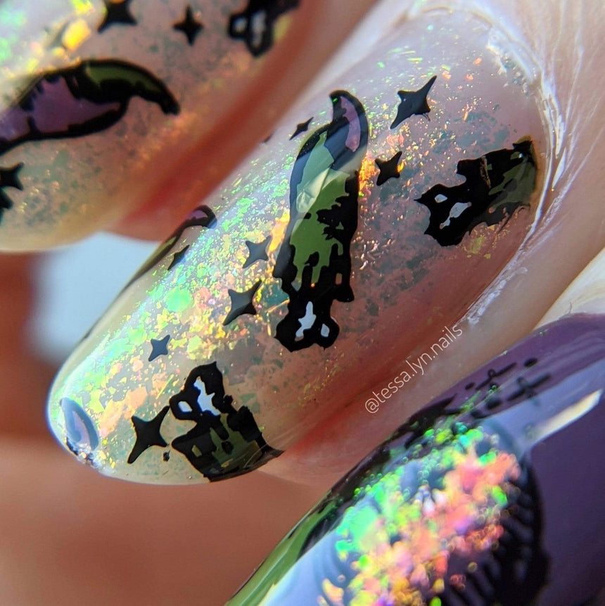 A manicured hand with Transparent Orange Iridescent Flakies by Maniology Illusion (NA027).