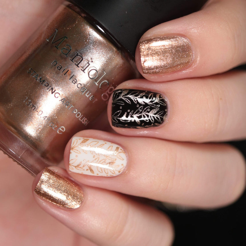 A manicured hand made with Metallic Pale Peach-Beige Orange holding a polish by Maniology (B361).