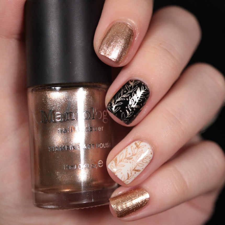 A manicured hand made with Metallic Pale Peach-Beige Orange holding a polish by Maniology (B361).