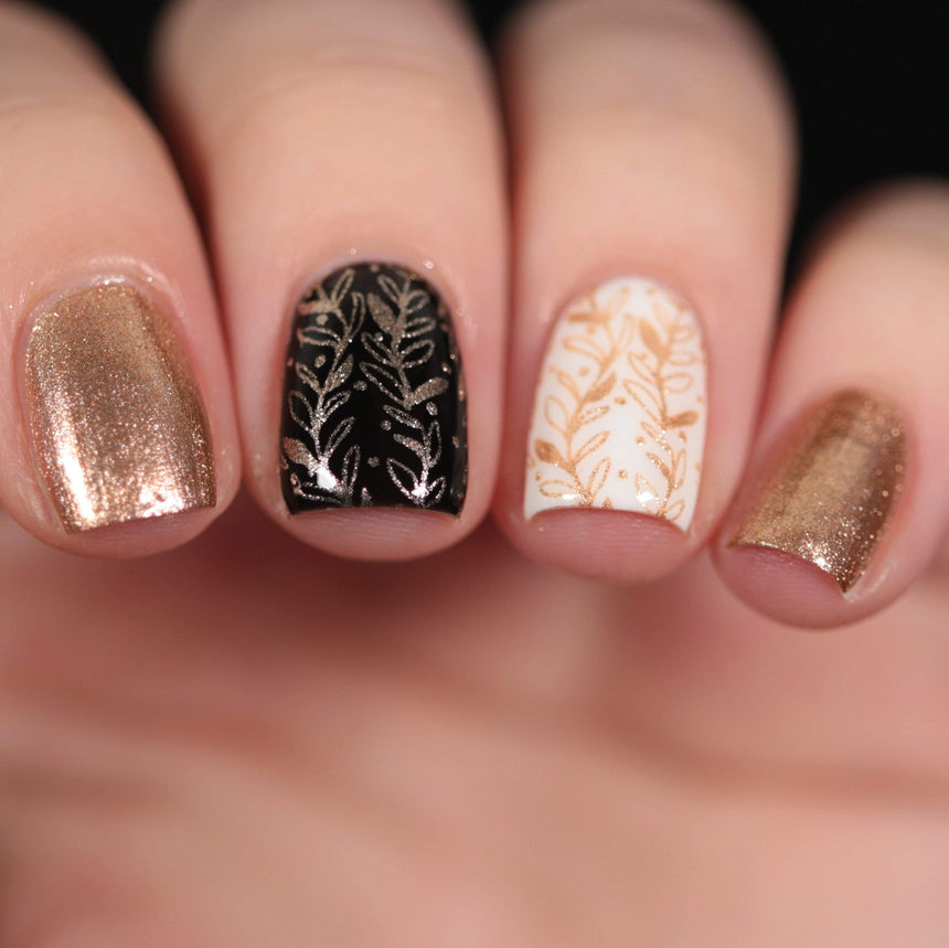 A manicured hand made with Metallic Pale Peach-Beige Orange Stamping Polish by Maniology (B361).