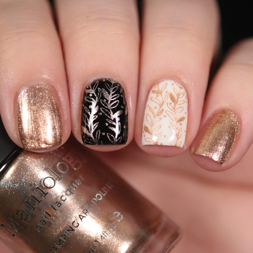 A manicured hand made with Metallic Pale Peach-Beige Orange holding a polish by Maniology (B361).