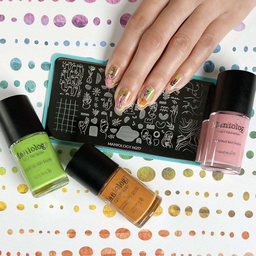 Manicured hand featuring Juicy polishes and M217 from Maniology