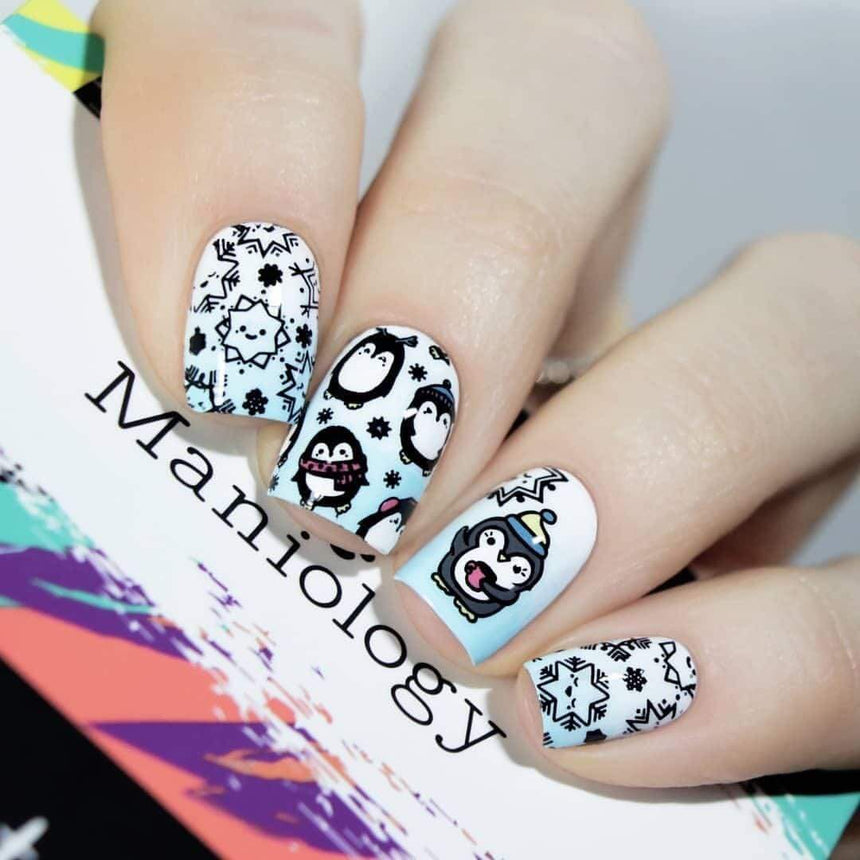 A manicured hand with penguins design holding a scraper by Maniology (m038).