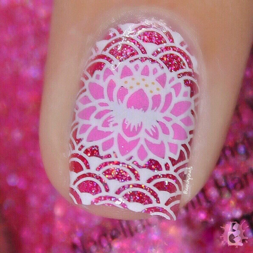 A manicured hand in pink and red in a buffet-style design.