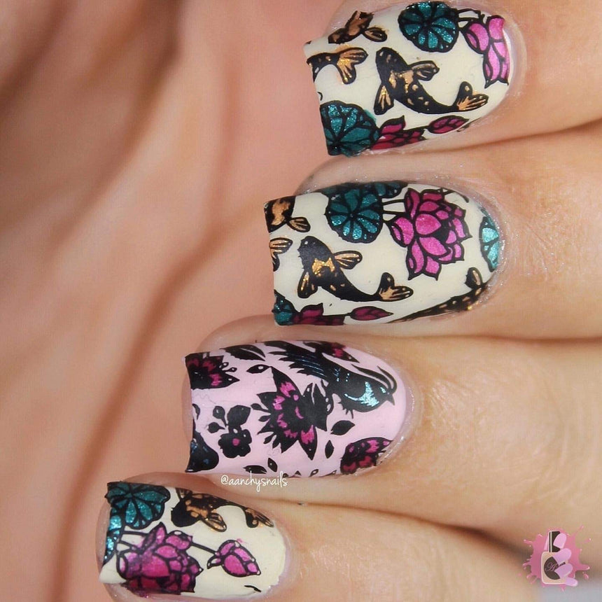 A manicured hand with koi fish and flowers design