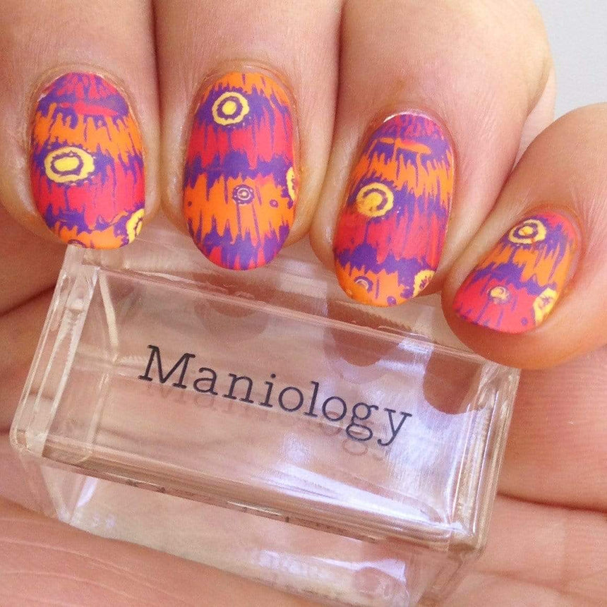 A manicured hand made with Purple Stamping Polish Littlefoot (B281) holding a stamper by Maniology.