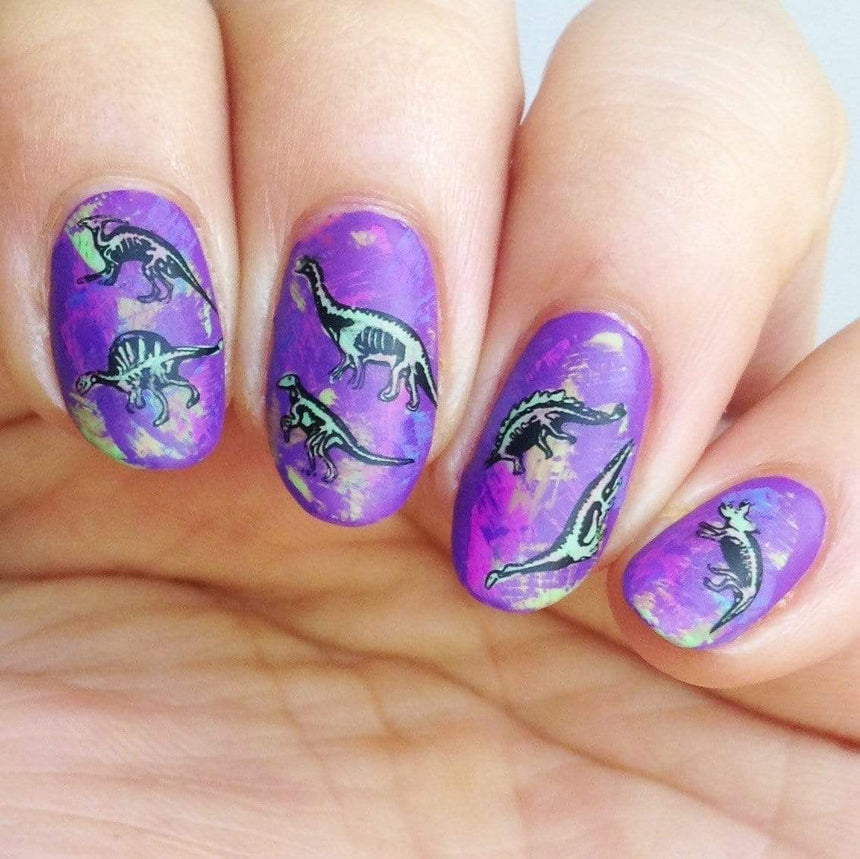 A manicured hand made with Purple Stamping Polish Littlefoot (B281) by Maniology.