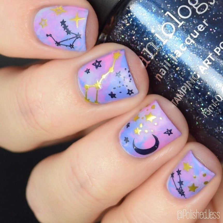 A manicured hand holding a Dark Navy Shimmer Stamping Polish by Maniology (B239).