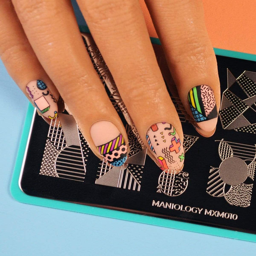 A manicured hand made with creamy pastel pink Salmon Stamping Polish Flashdance (B284) by Maniology.