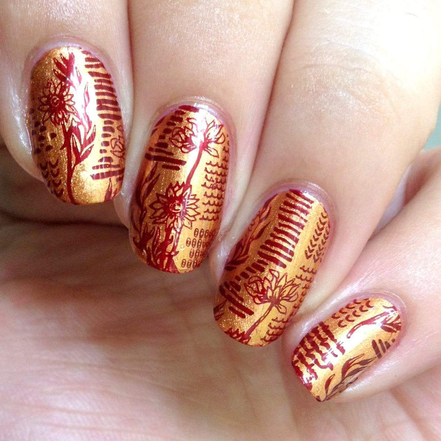 A manicured hand with Copper Orange Stamping Polish.