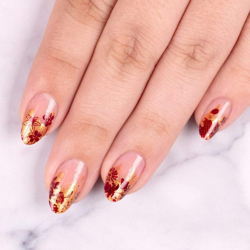 A manicured hand with Copper Orange Stamping Polish.