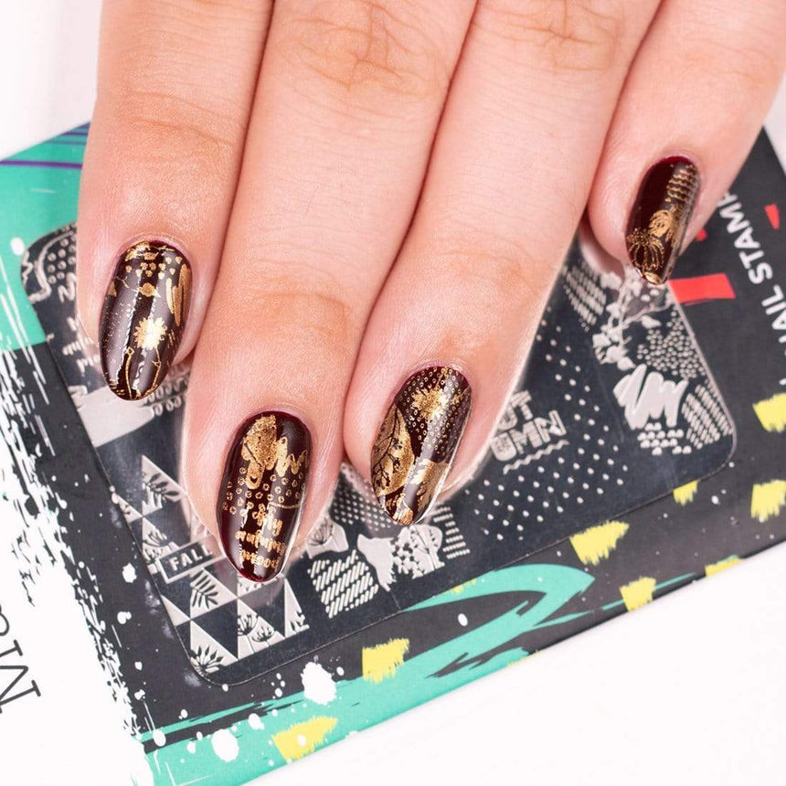 A manicured hand with Copper Orange Stamping Polish.