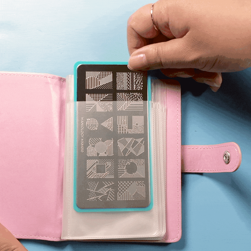 A Mini Pineapple Stamping Plate Organizer that can stores up to 16 XL stamping plates and displays them with sheer white pockets.