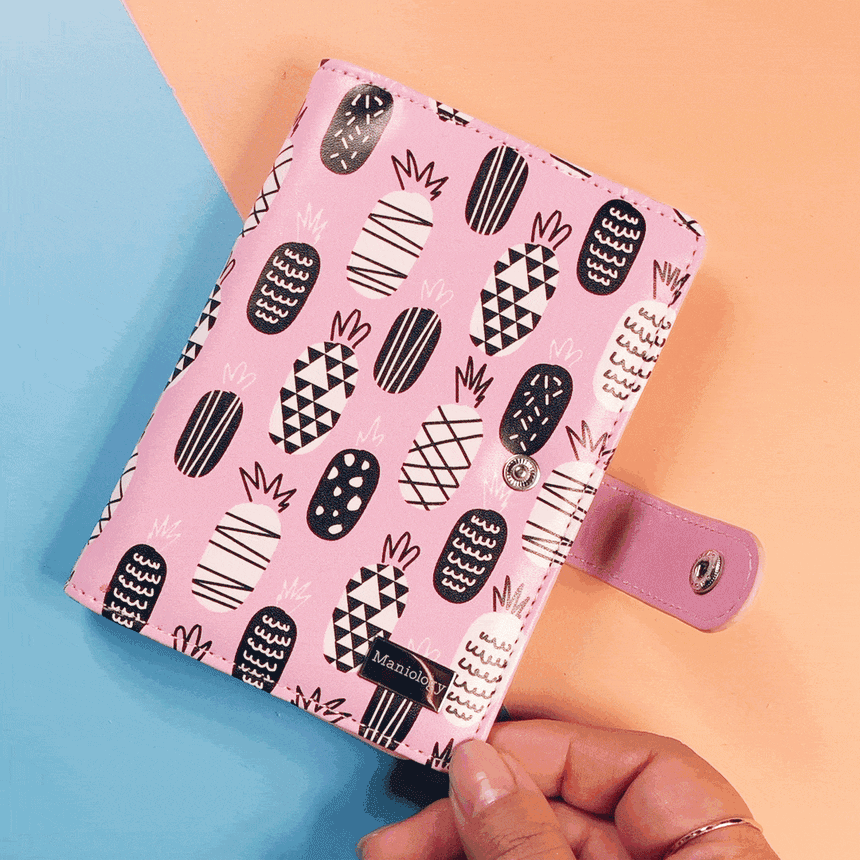 A Mini Pineapple Stamping Plate Organizer that can stores up to 16 XL stamping plates and displays them with sheer white pockets.