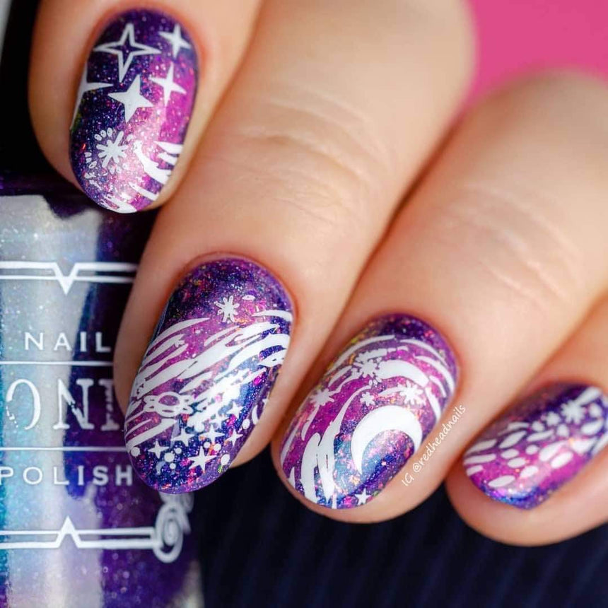 A manicured hand with Negative Space: Starry Night design by Maniology (m024) holding a polish.
