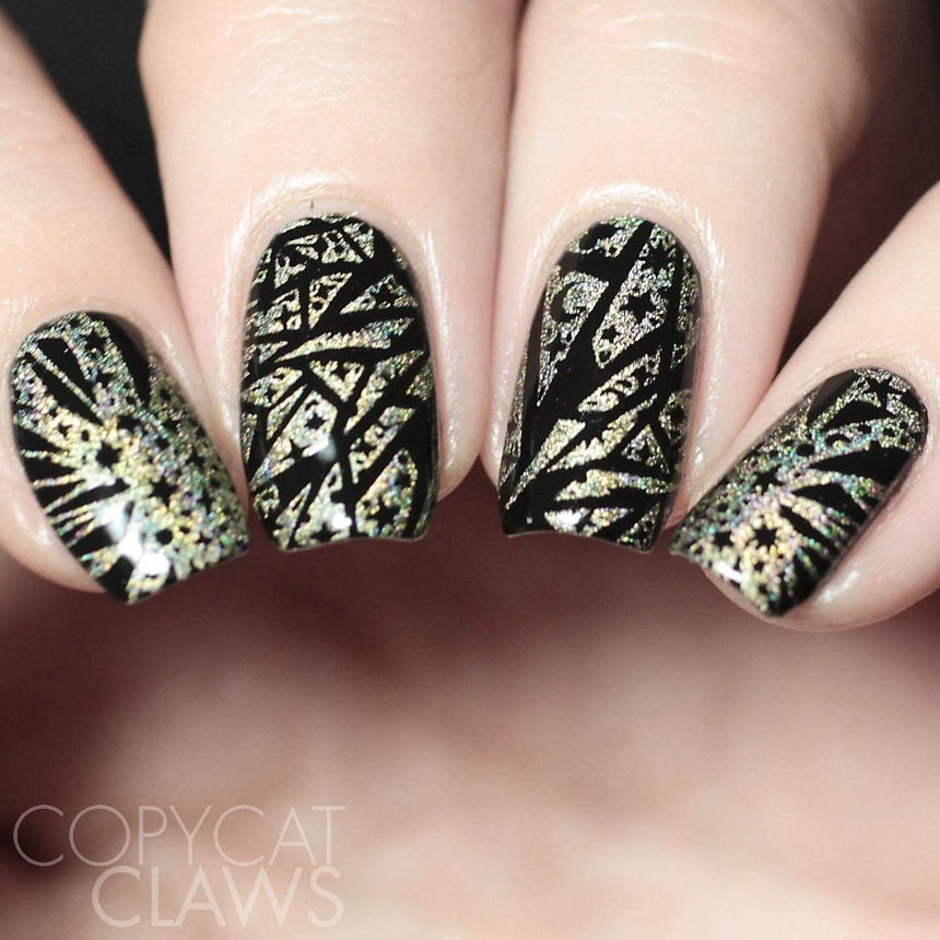 A manicured hand in black and gold with Negative Space: The Crack in Space designs by Maniology (m025).