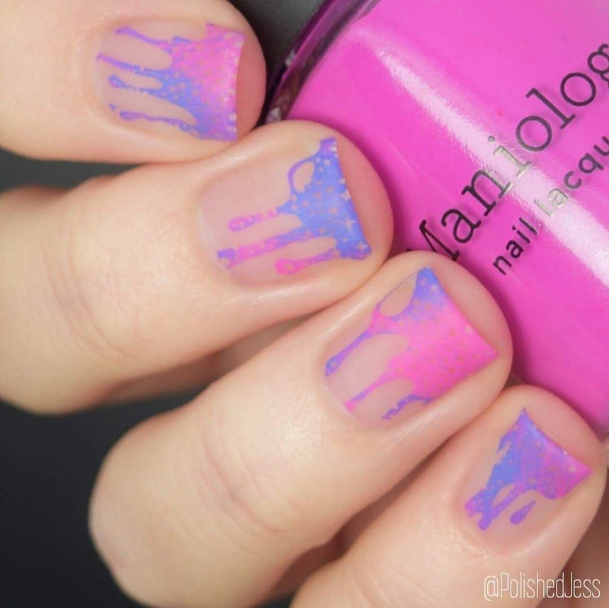 A manicured hand with Negative Space: The Crack in Space designs holding a polish by Maniology (m025).