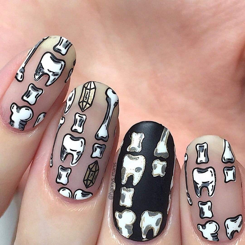 A manicured hand made with Straight Up Black (B171) and WHITE (B170) stamping polishes by Maniology.