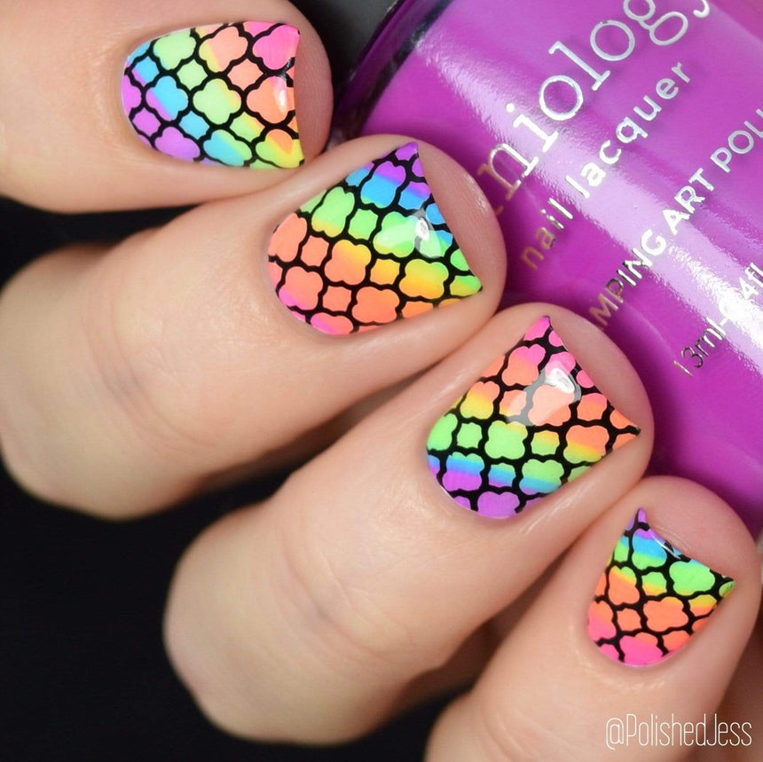 A manicured hand holding Stamping Polish from School's Out collection Food Fight.