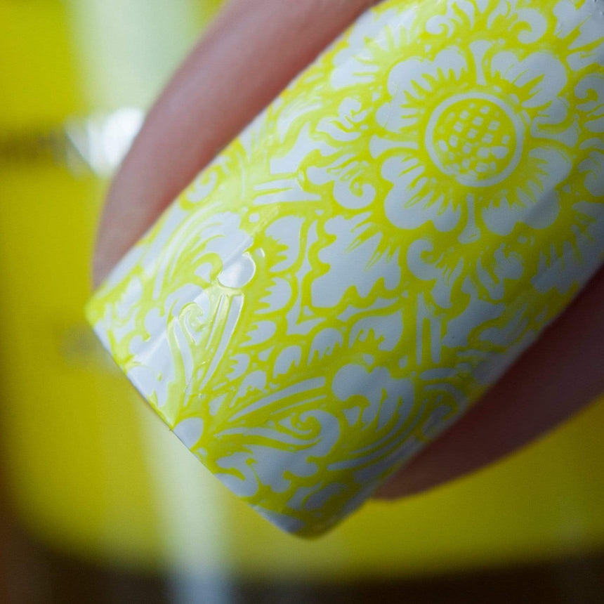 A manicured hand made with Neon Yellow Stamping Polish from School's Out collection Pencils Down (B286).