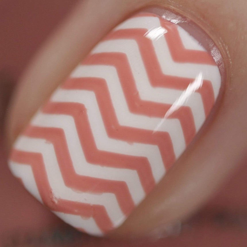 A manicured hand made with Blush Pink Stamping Polish from Stocking Stuffer: Cinnablush (B313).