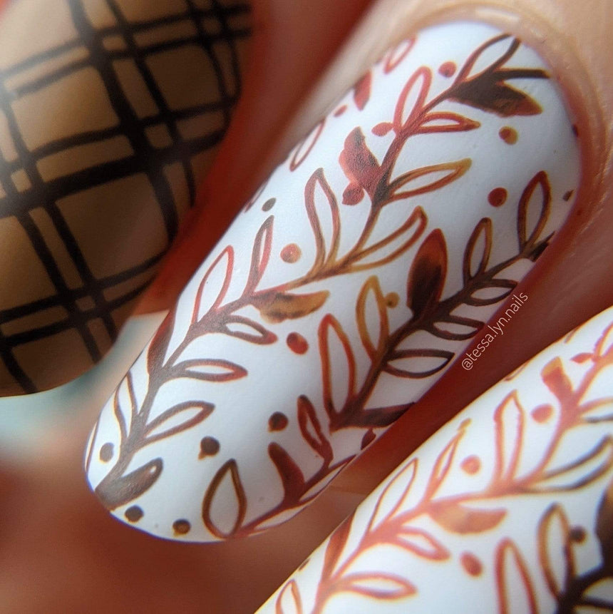 A closeup manicure featuring fall colors and leaves.