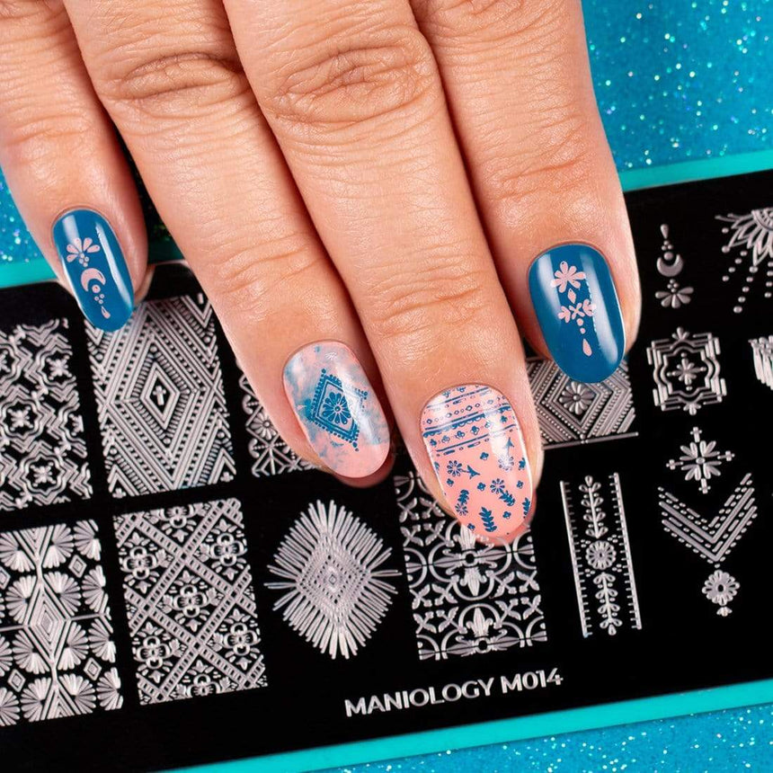 A manicured hand with stamping plate m014 designs.