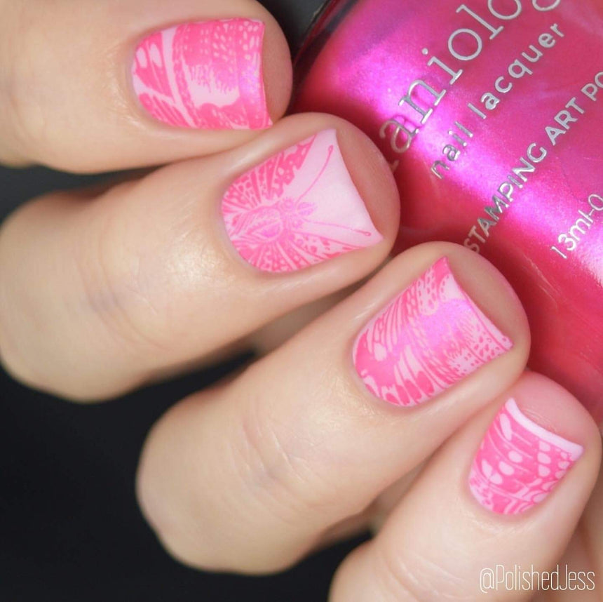A manicured hand holding Wild Wings (B294) Hot Pink Duochrome Stamping Polish by Maniology.